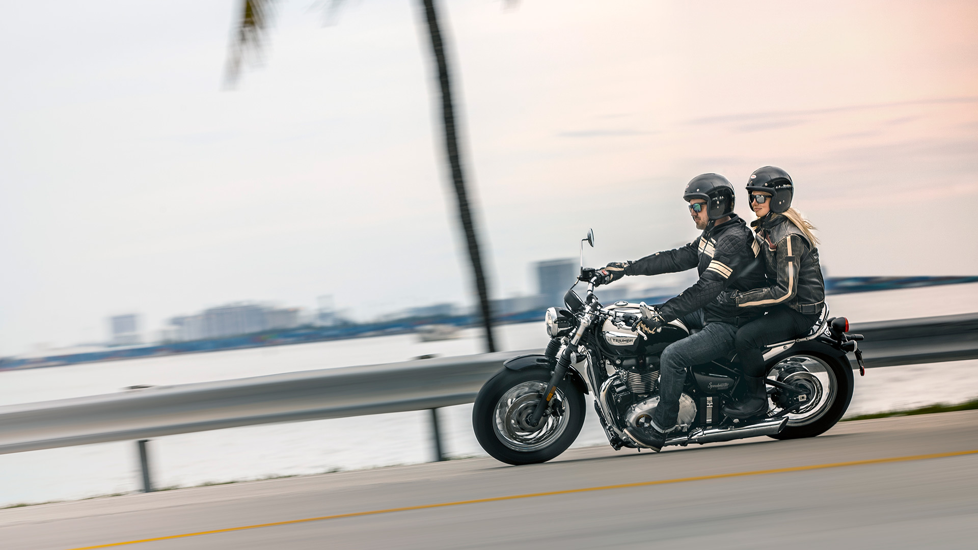 Man and woman riding Triumph Bonneville Speedmaster on road