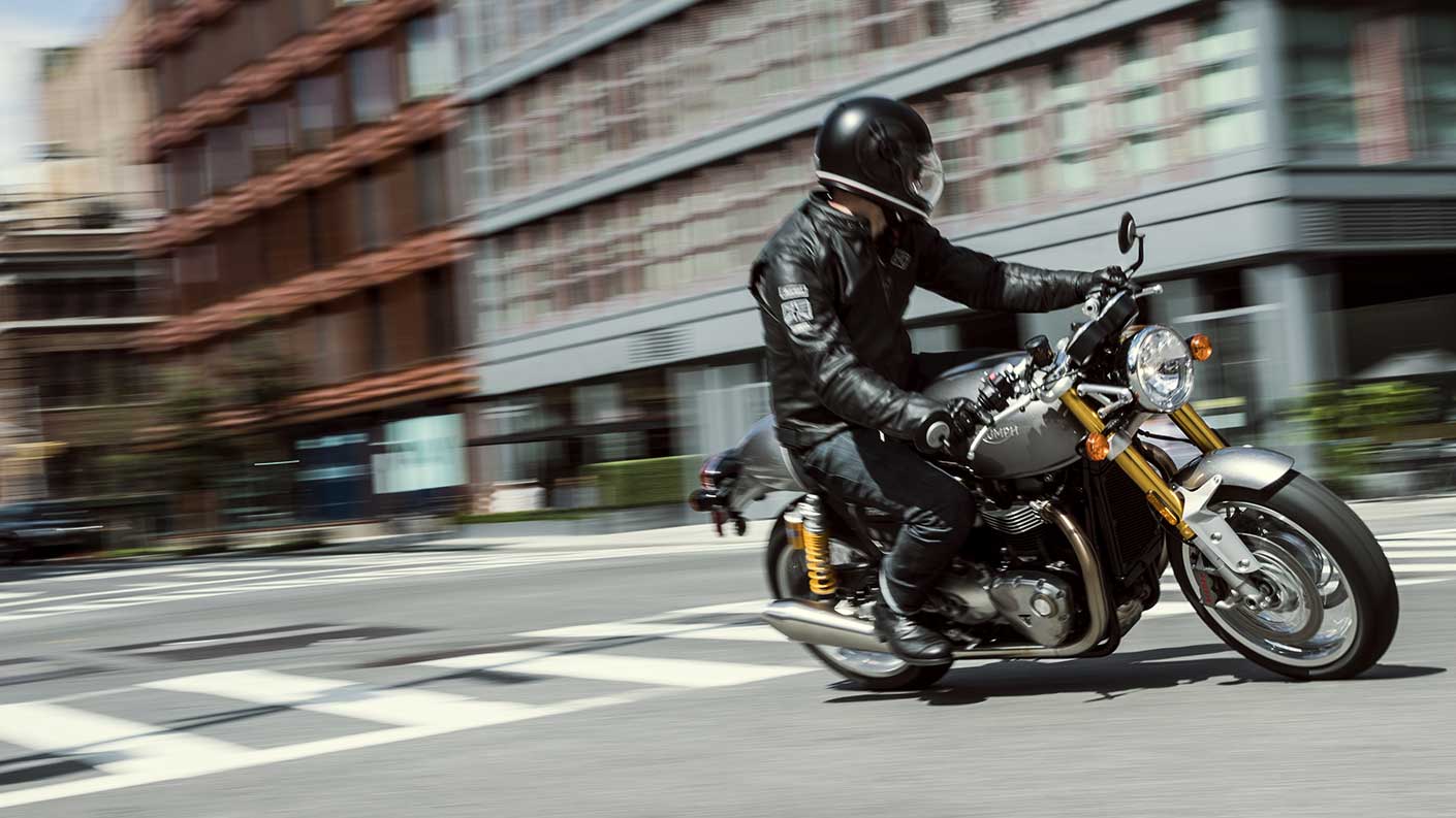 Silver Triumph Thruxton 1200 R urban riding shot